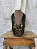 Collar multi negro con tubos dorados